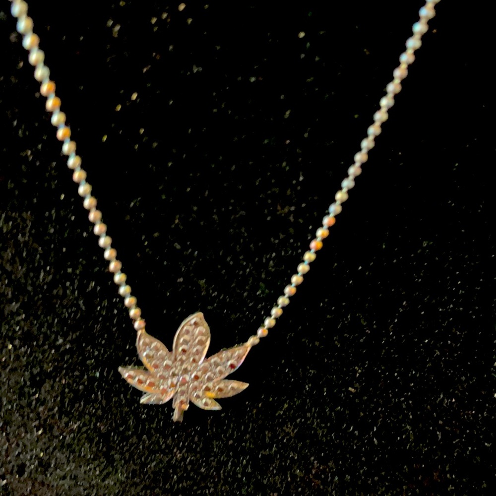 Oxidized silver hemp leaf necklace by Fisou jewelry.